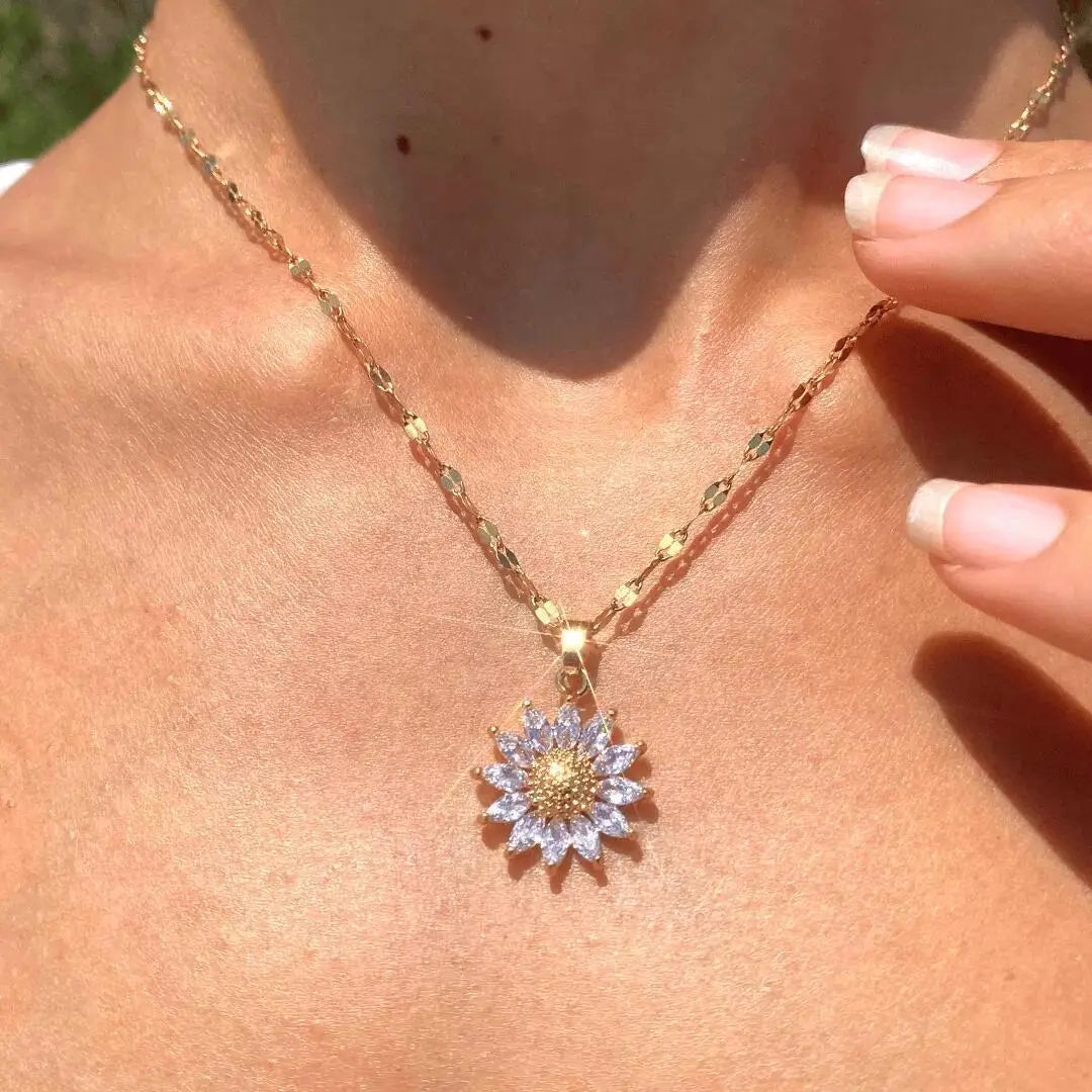 Model wearing gold-tone sunflower necklace with minimalist outfit