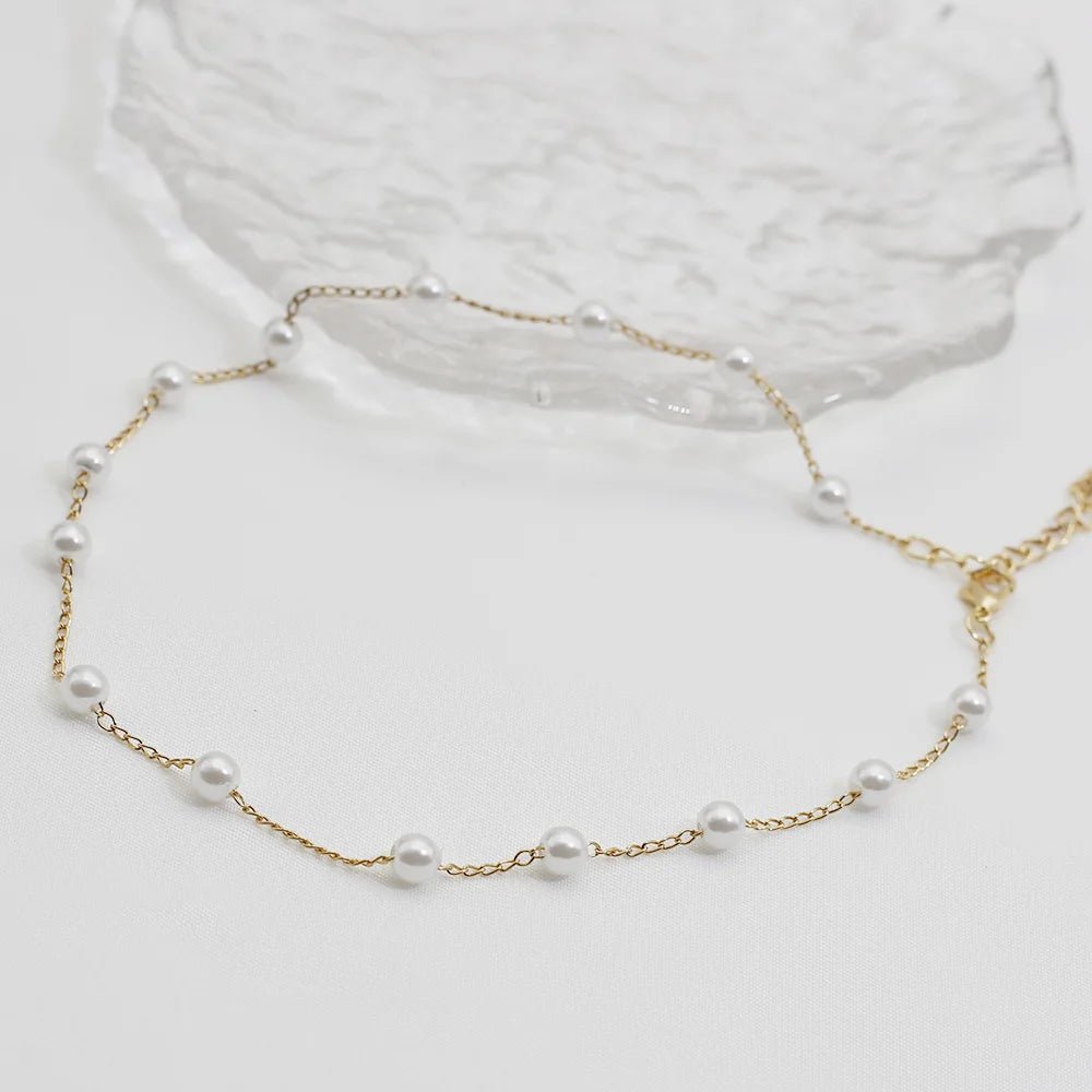 Romantic pearl choker with gold accent – flat lay composition | Dainty Diana