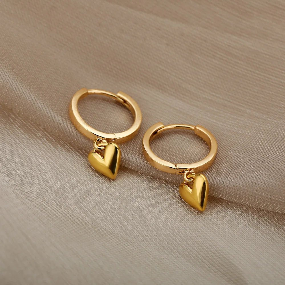 Polished gold heart earrings – side angle | Dainty Diana