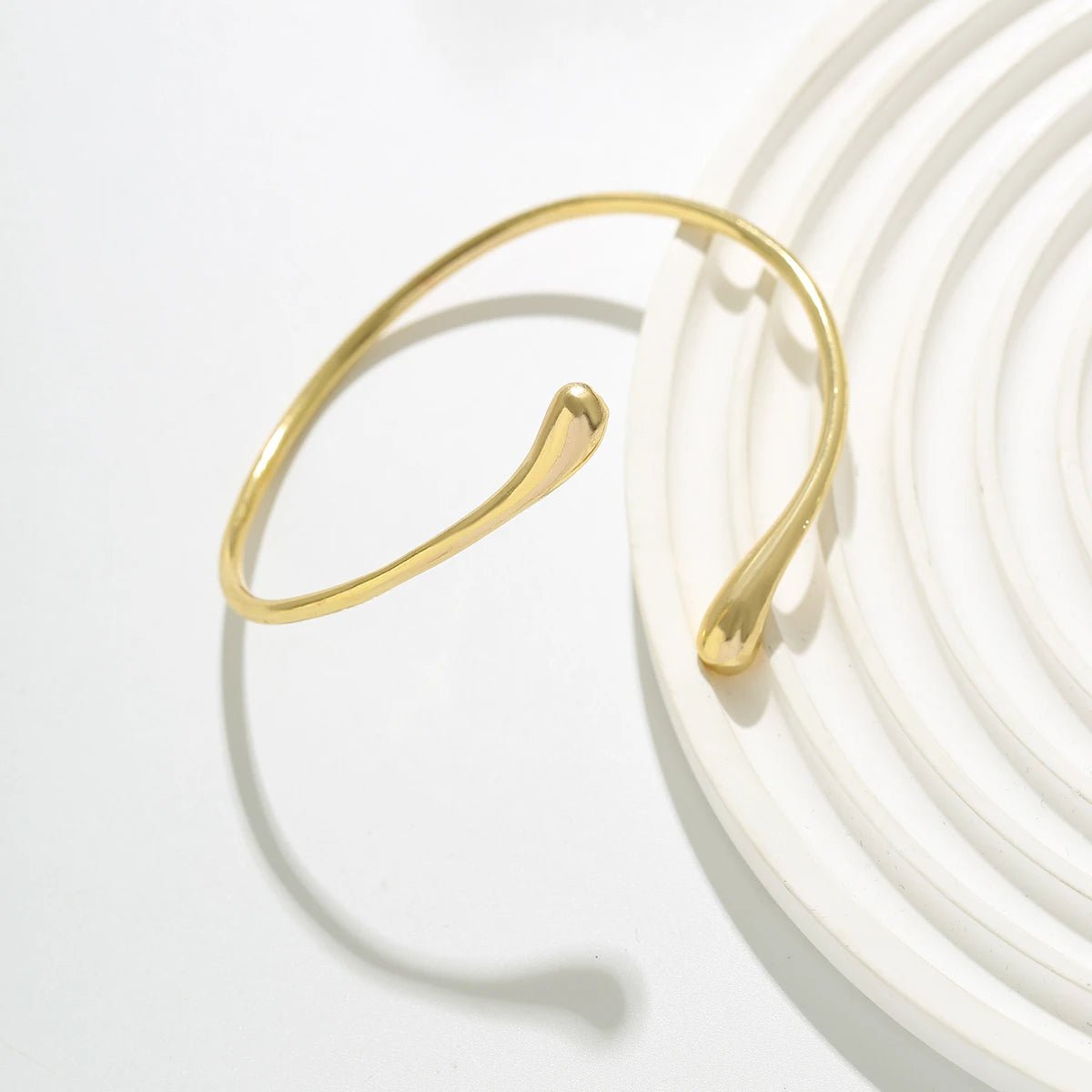 Sculptural gold cuff with waterdrop silhouette – angled shot | Dainty Diana