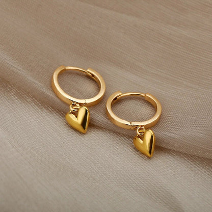Polished gold heart earrings – side angle | Dainty Diana