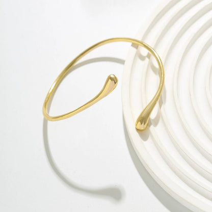 Sculptural gold cuff with waterdrop silhouette – angled shot | Dainty Diana